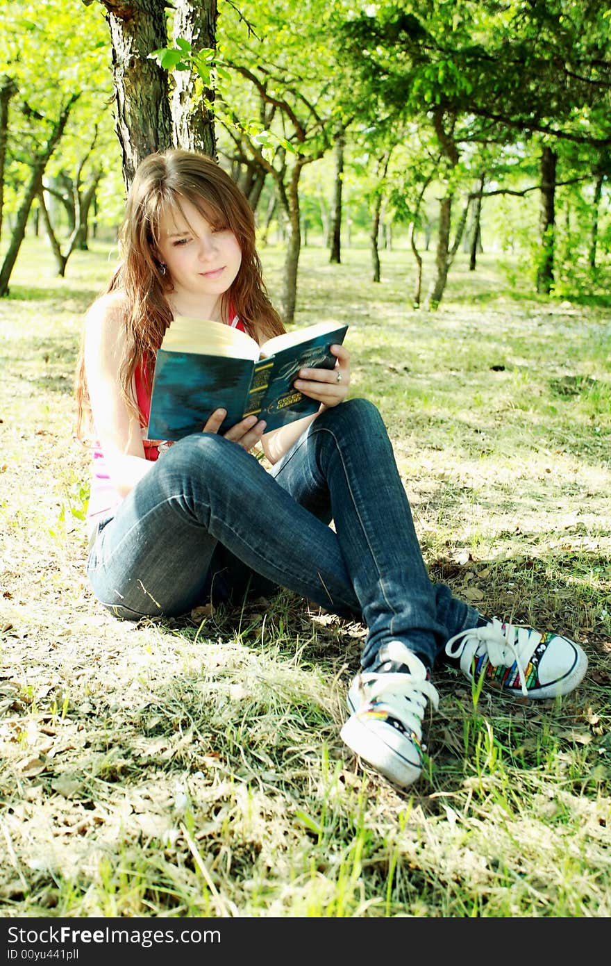 Beautiful girl read the book and lying on Grass. Beautiful girl read the book and lying on Grass