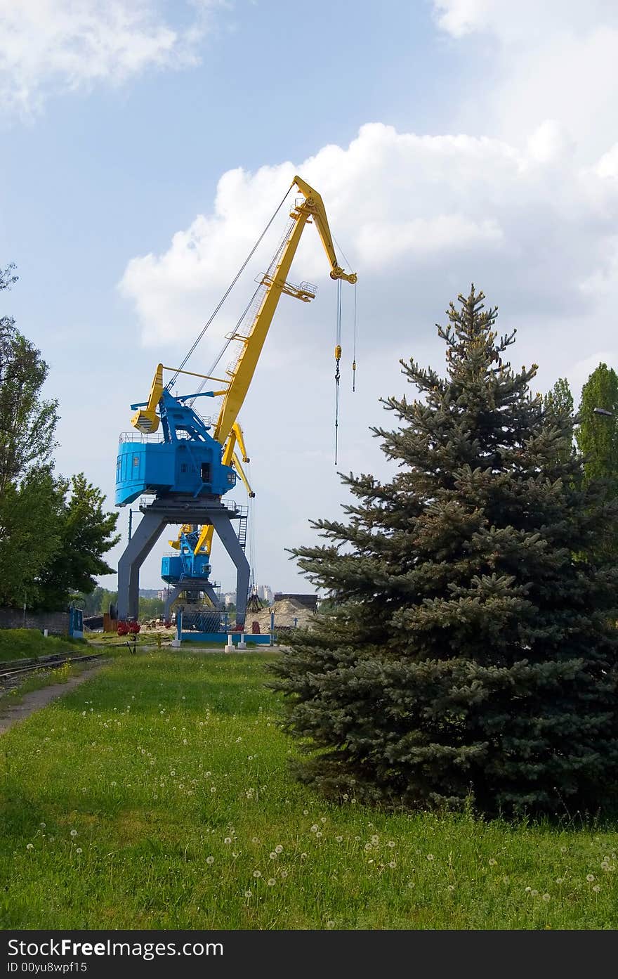 The elevating crane in an operating time and a fur-tree. The elevating crane in an operating time and a fur-tree