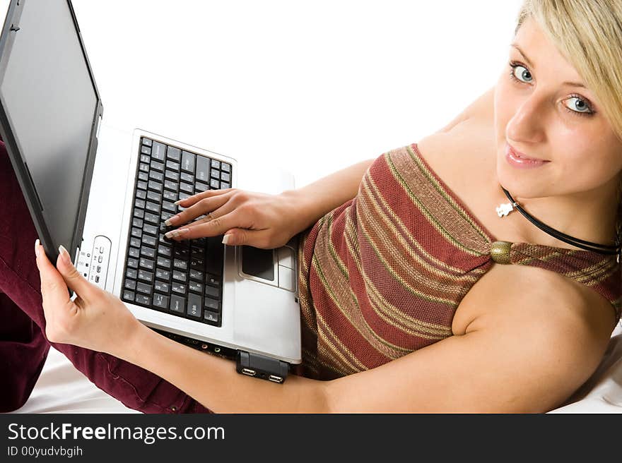 Young beautiful girl working with laptop. Isolated