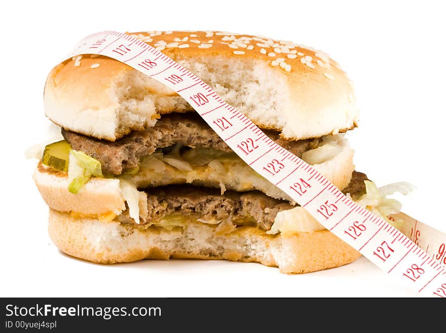 Bread with fried meat, cheese, onion, lettuce and measuring tape isolated on a  white background. Bread with fried meat, cheese, onion, lettuce and measuring tape isolated on a  white background.