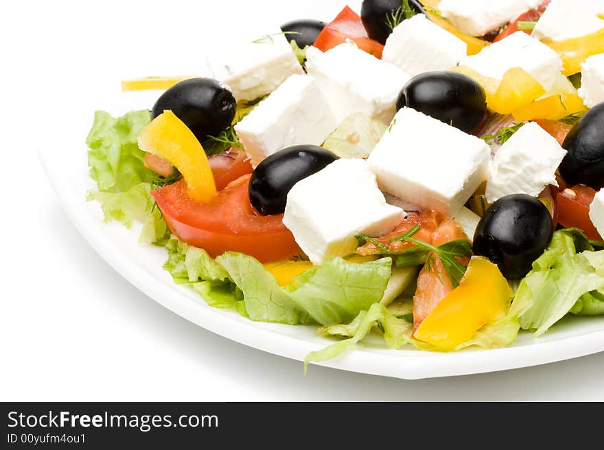 Appetizing greeak salad on a plate. Close up. Appetizing greeak salad on a plate. Close up.