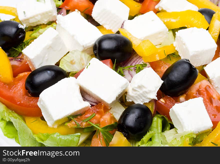 Appetizing greeak salad on a plate. Close up. Appetizing greeak salad on a plate. Close up.