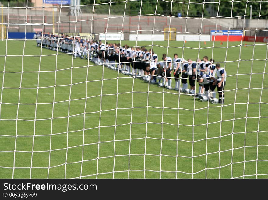 Net with american football players 
focus on net