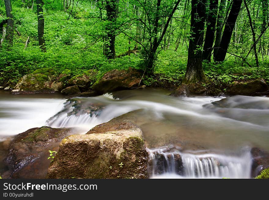 An image of a waterfall in spring forest