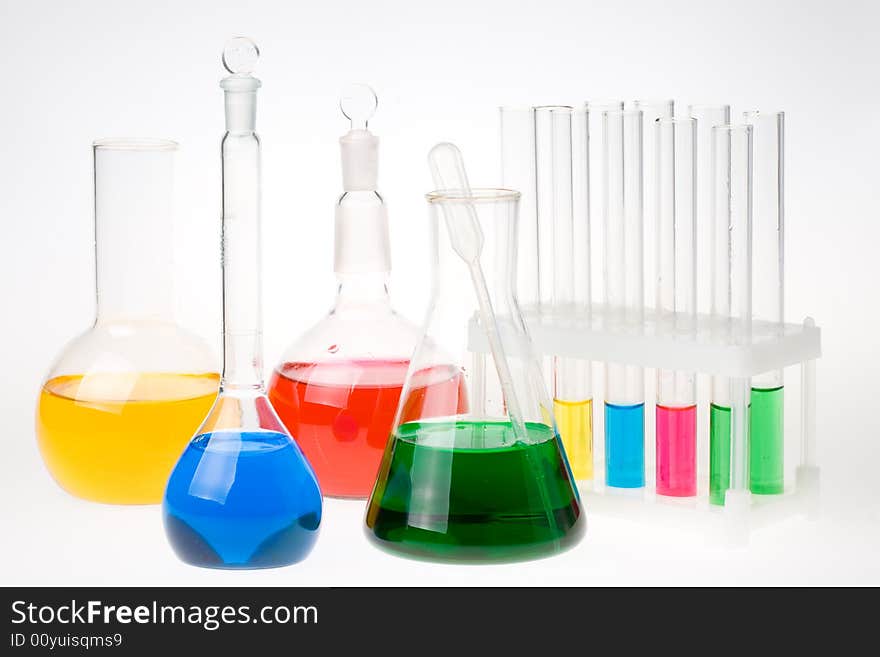 Various colorful glass laboratory ware on a white background. Various colorful glass laboratory ware on a white background