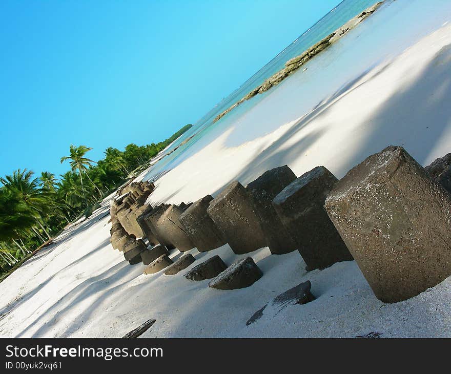 Stone barriers installed at the beach to stop the waves, A man's invasion in nature. Stone barriers installed at the beach to stop the waves, A man's invasion in nature