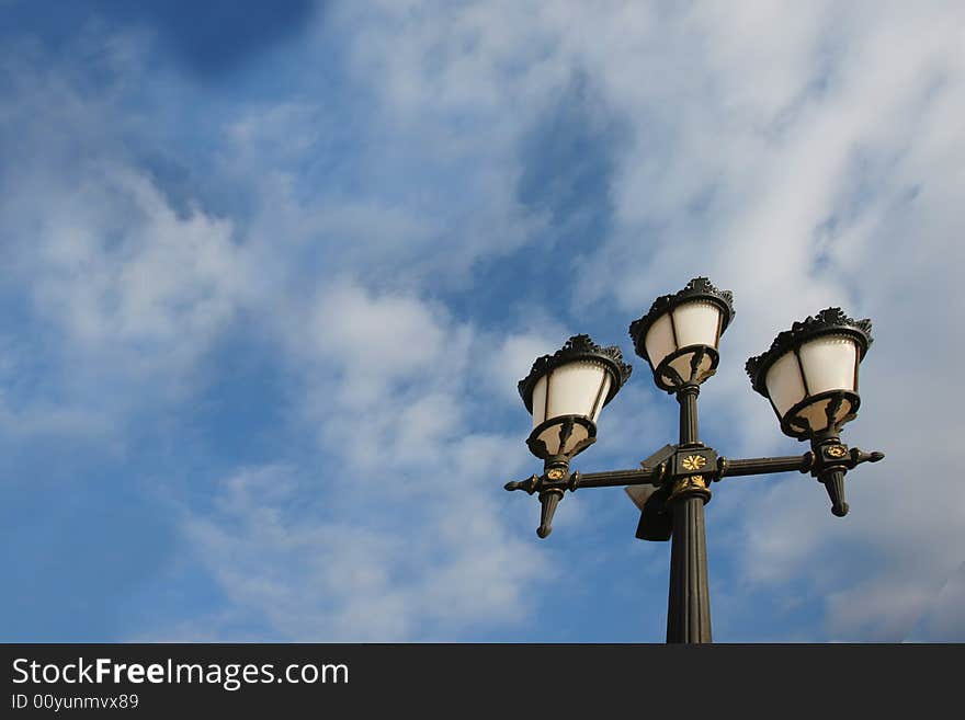 Old lamp against blue sky