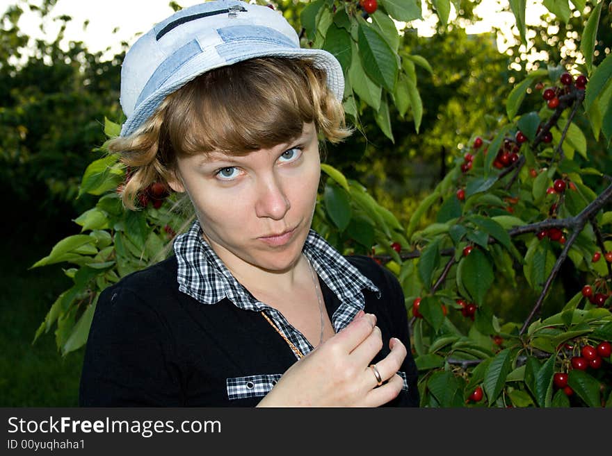 The young girl collects a sweet cherry