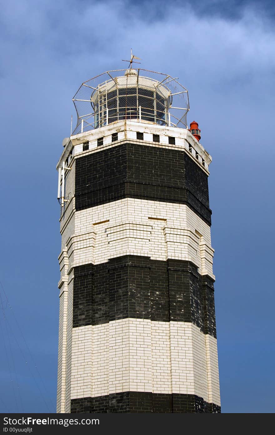 Beacon against the cloudy sky