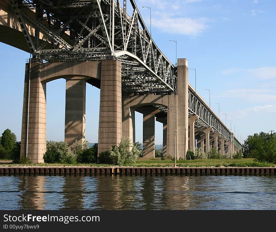 A steel bridge on concrete supports over the pier and canal. A steel bridge on concrete supports over the pier and canal.