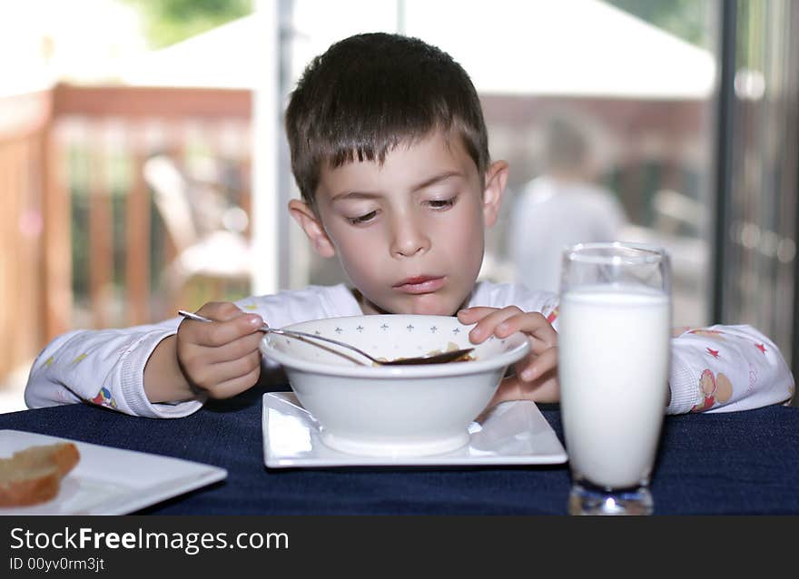 6 year old boy having breakfast in the morning. 6 year old boy having breakfast in the morning