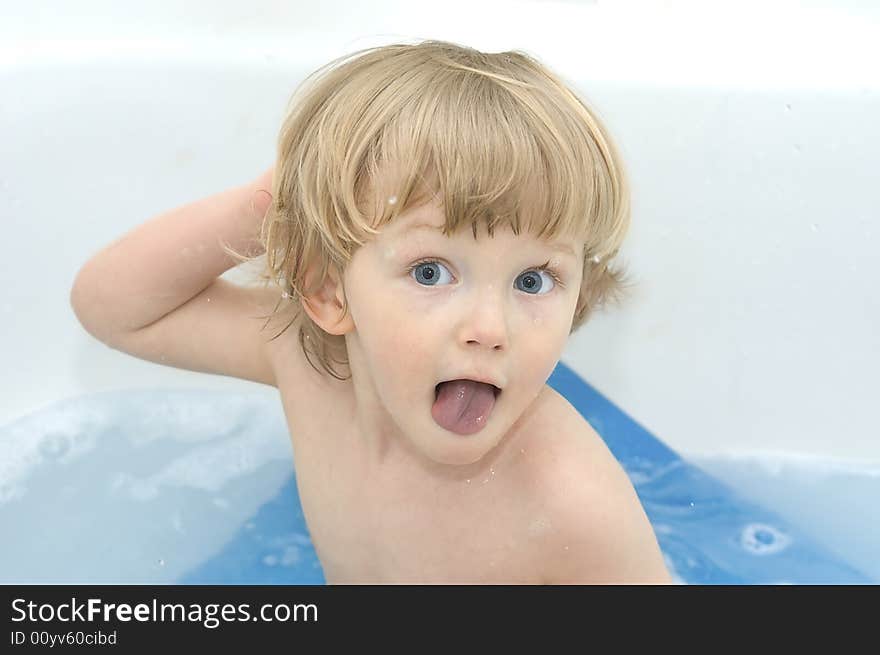 Cheerful boy on white background. In bath.