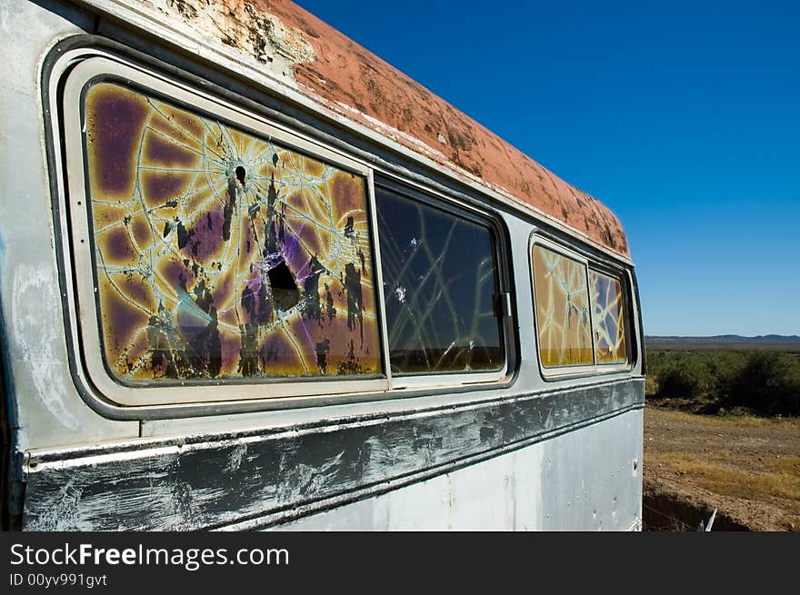 Abandoned bus in the patagonian steppe with broken windows.