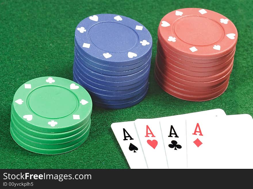 Playing cards and poker jetons on green background. Playing cards and poker jetons on green background