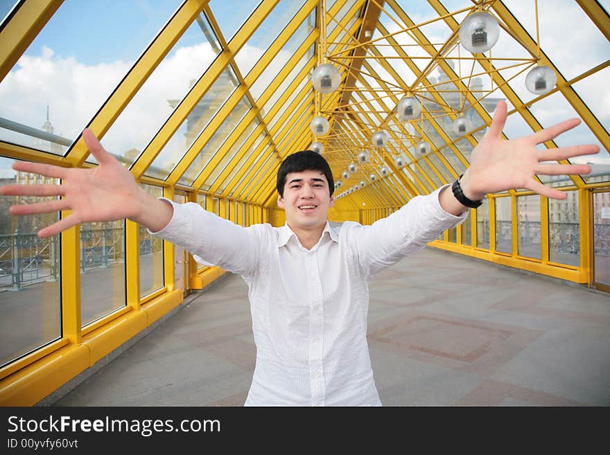 Young asian man shows salutatory gesture