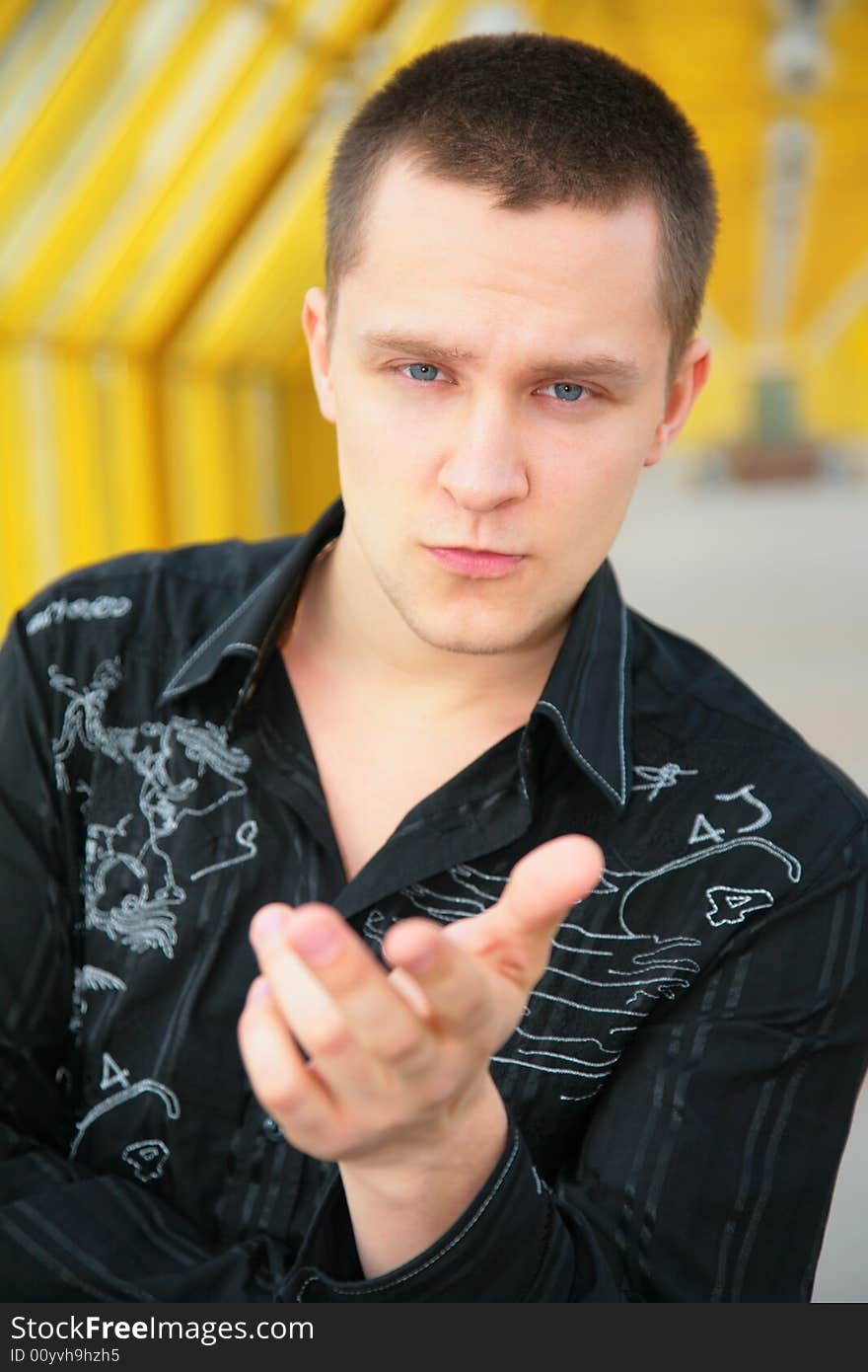 Serious young man on footbridge