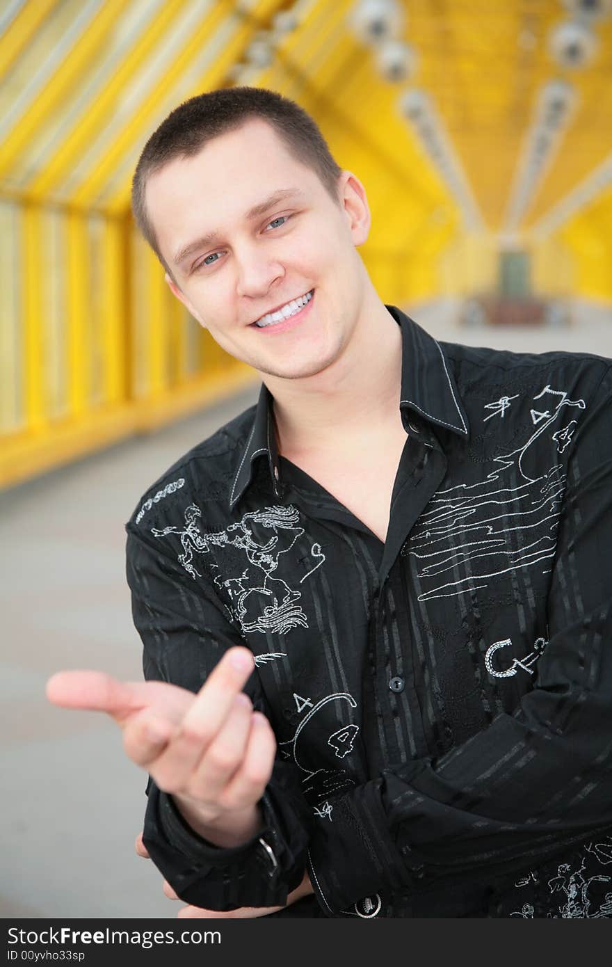 Smiling boy in black shirt makes gesture