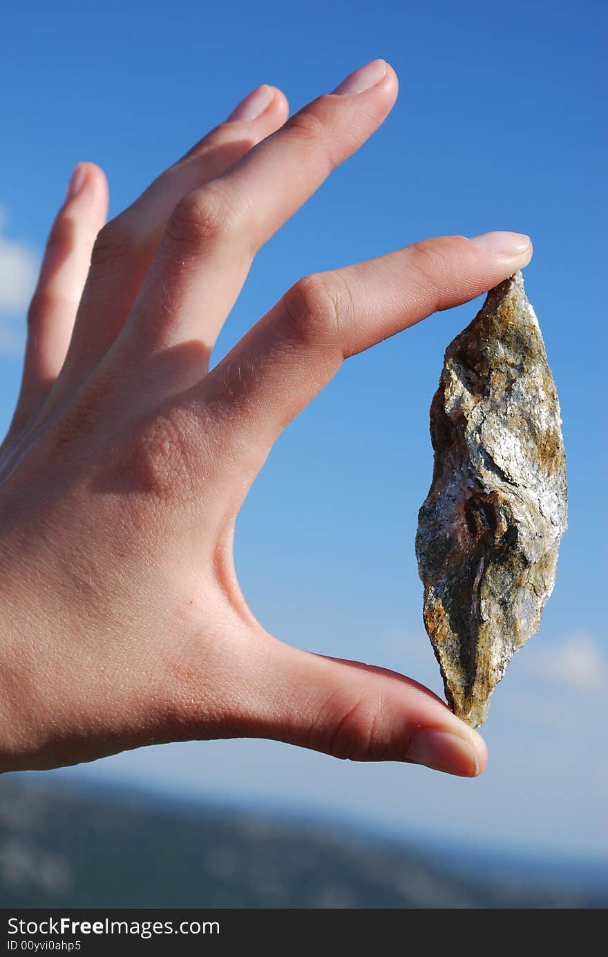 Mica in the mountains & hand on blue sky. Mica in the mountains & hand on blue sky