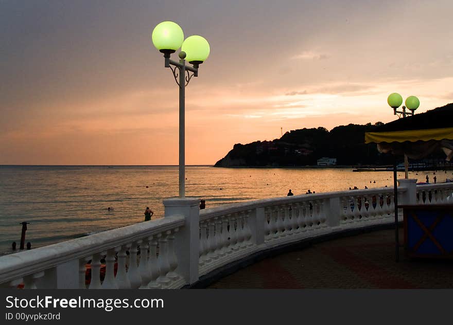 Lamp on the sea-front in the summer evening