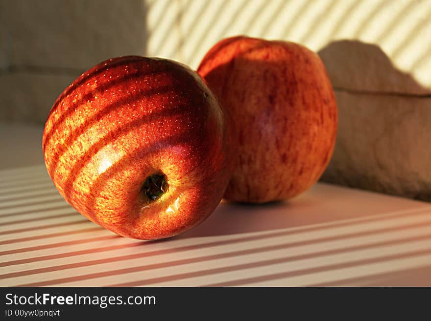 Apples in sunlight on a white table