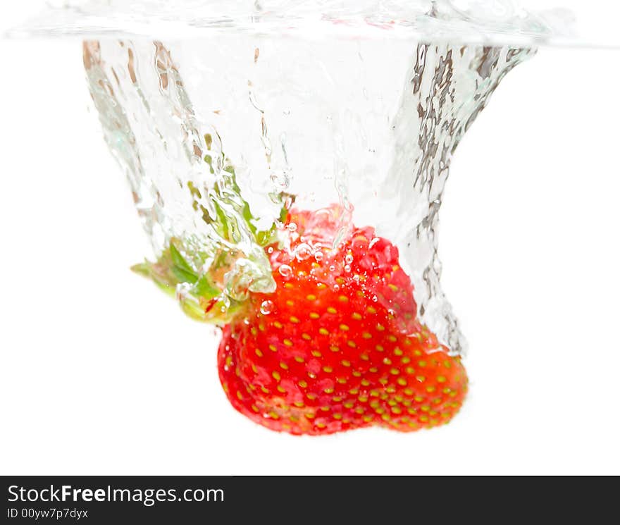 Close-up splashing strawberry, isolated on white