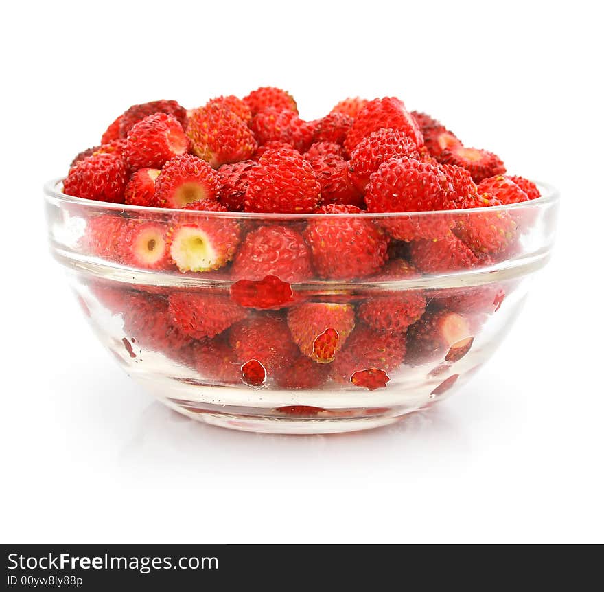 Red strawberry fruits in glass vase isolated on white background