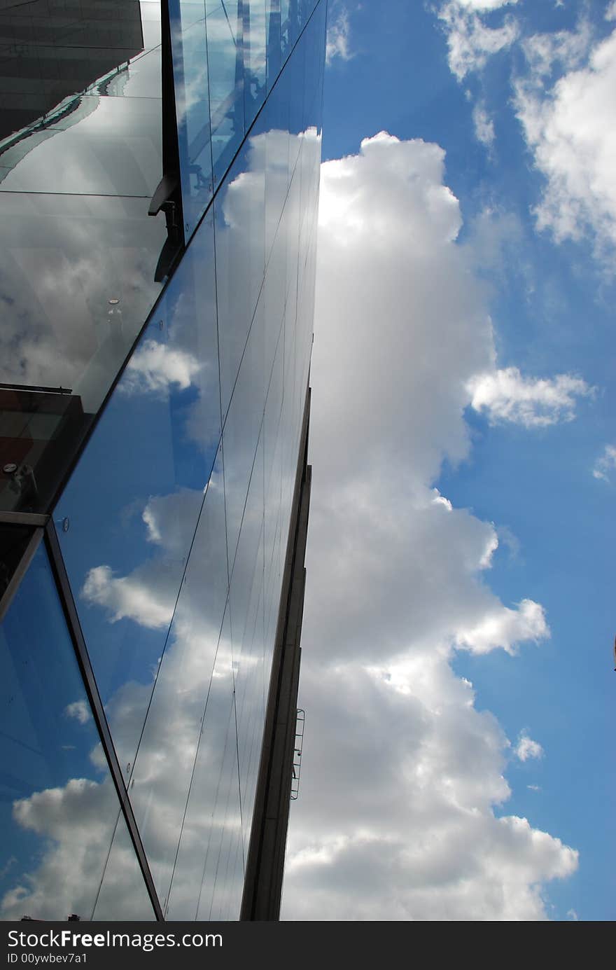 Glass building wall with clouds