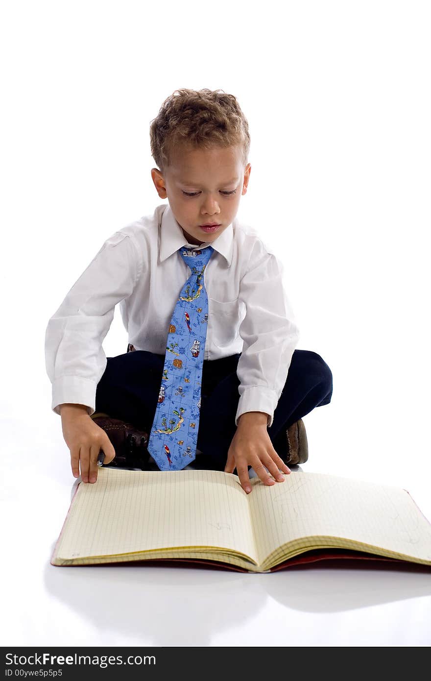 Young boy dressed as businessman with notebook