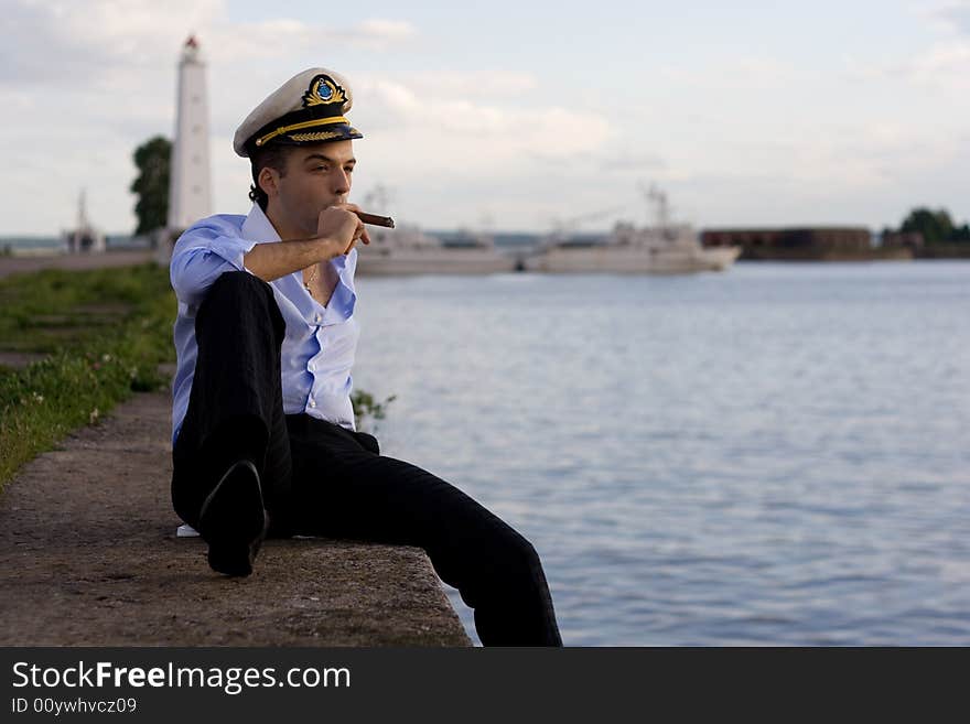 The men with cigarette smoke on the pier. The men with cigarette smoke on the pier.