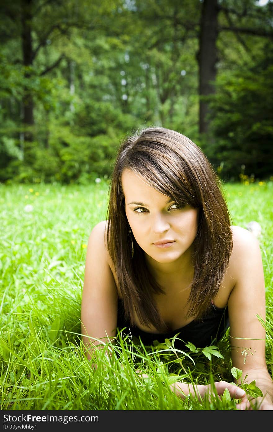 Beautiful girl lying down of grass. Copy space. Beautiful girl lying down of grass. Copy space