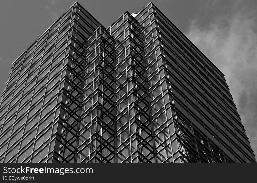 An interesting glass building rises up towards the clouds. An interesting glass building rises up towards the clouds