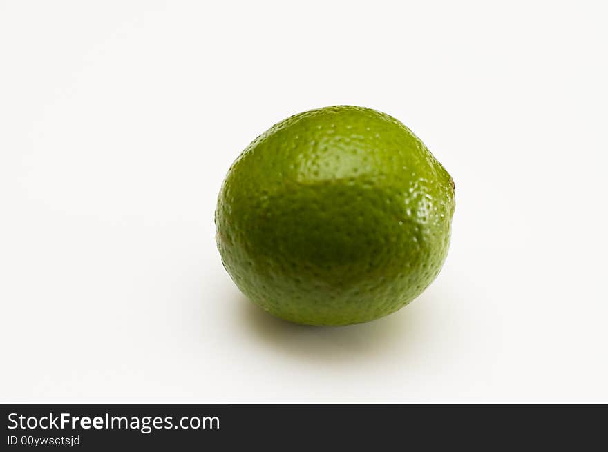 A ripe, round lime ready for summer drinks. A ripe, round lime ready for summer drinks