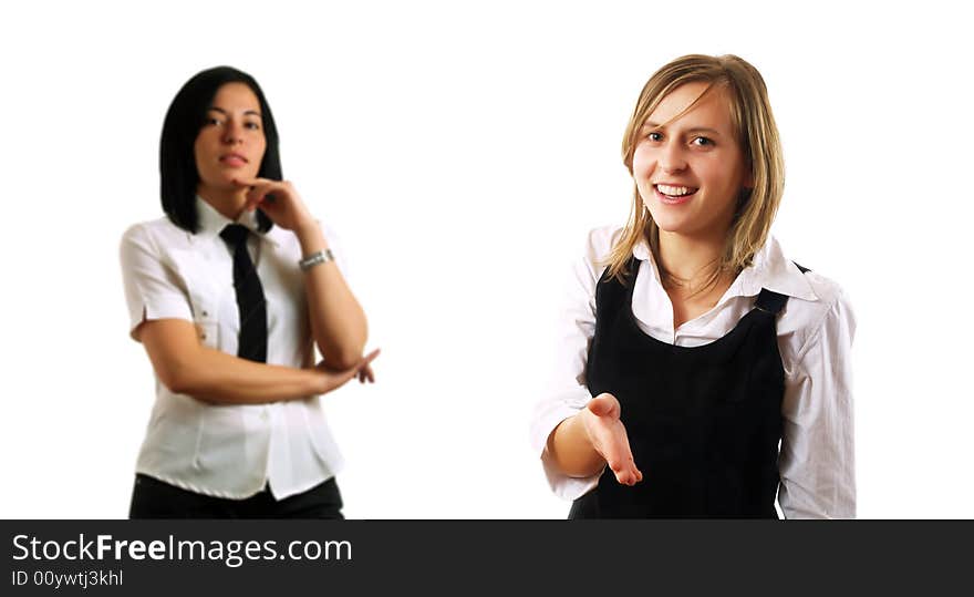 A young pretty businesswoman is holding her hand out for saluting a business partner. Behind her there is her boss. They are smiling and they are wearing elegant shirts. A young pretty businesswoman is holding her hand out for saluting a business partner. Behind her there is her boss. They are smiling and they are wearing elegant shirts.