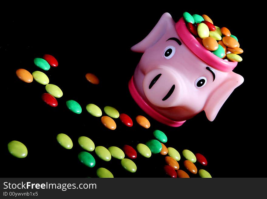 Many colored candies and a pig