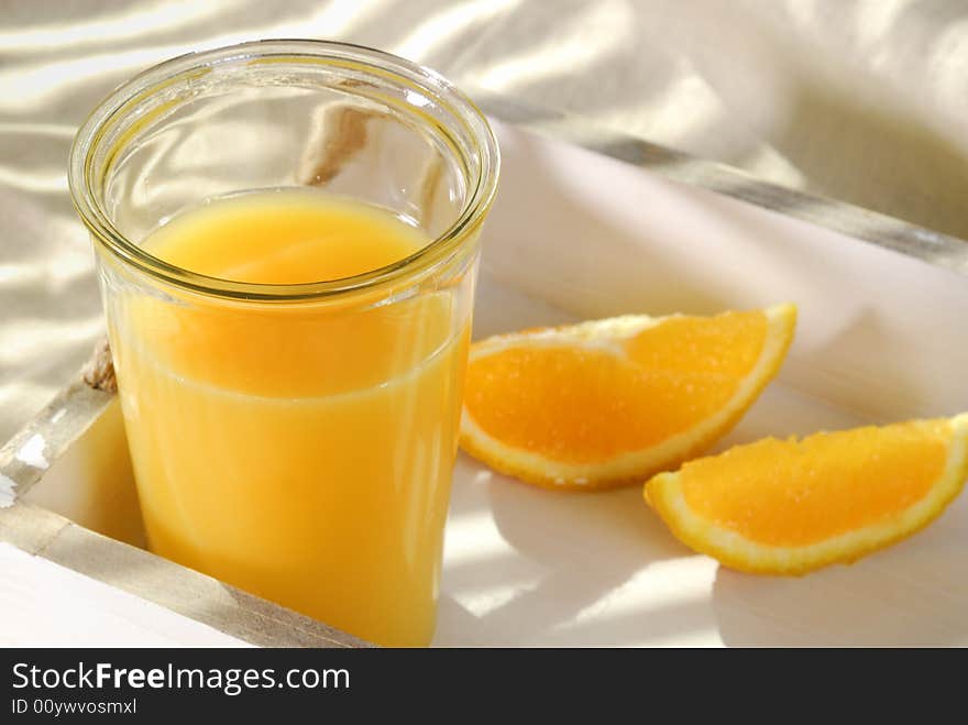 Orange juice in a glass on a tray