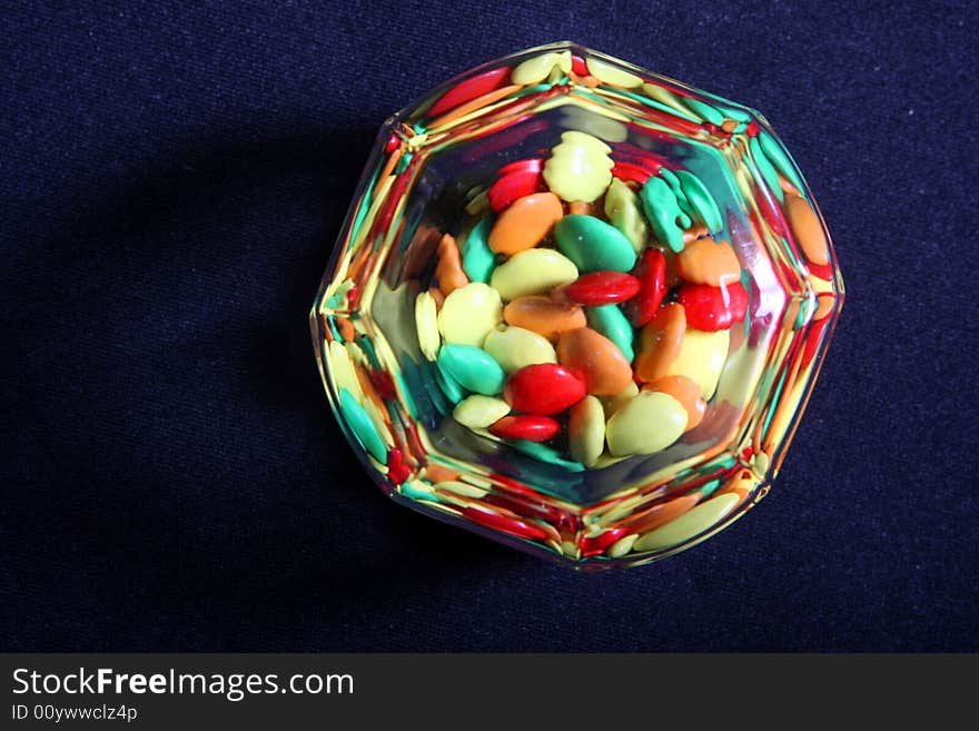 Many colored candies in a glass