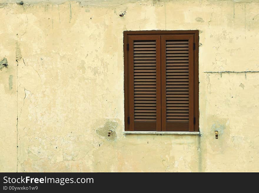 Brown window shutters on a beige wall