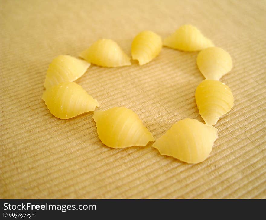 A love shape made by 9 pcs of pasta shell