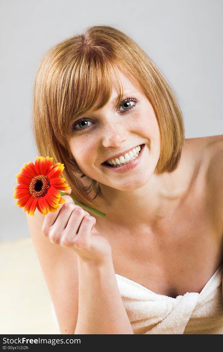 Young beautiful woman with a towel and falling flowers. Young beautiful woman with a towel and falling flowers