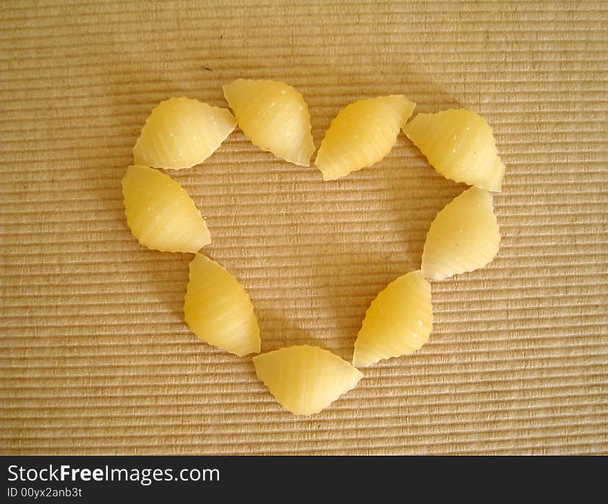 Top view of a love shape made by pasta shell