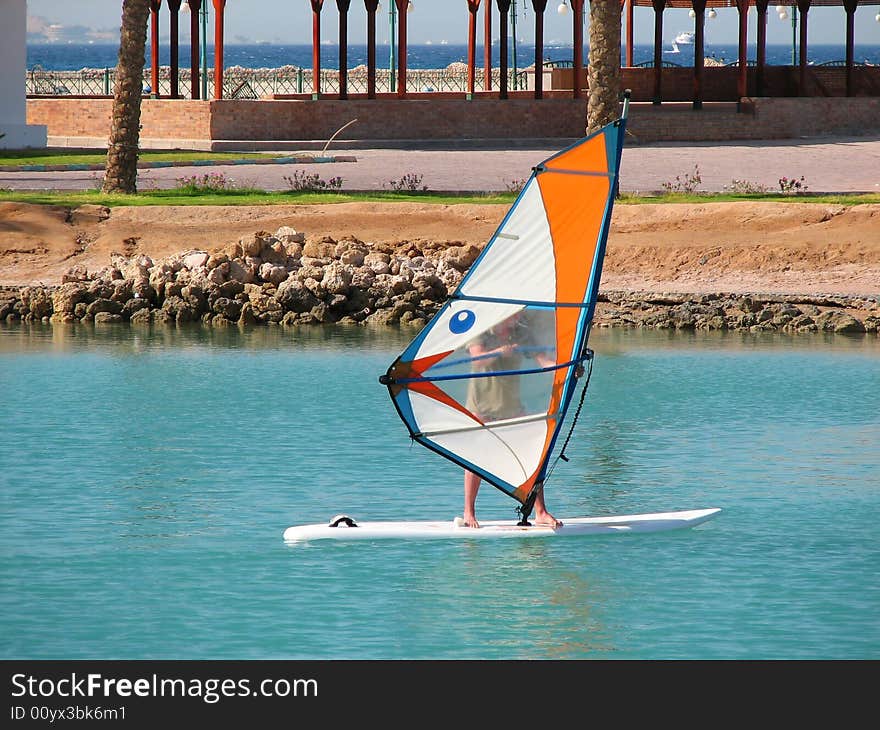 Man surfing on sea near coastline