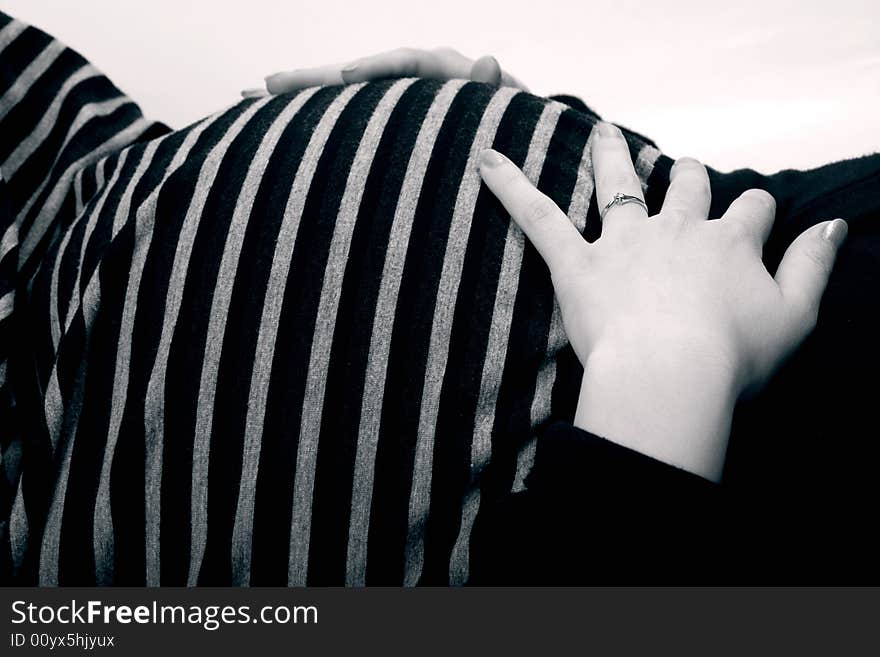 Pretty tummy of a pregnant woman in black and white