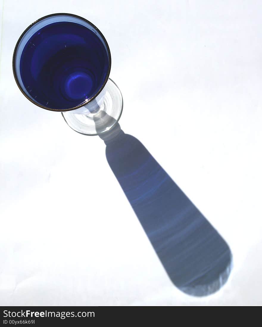 Blue glass with water on white background. Not isolated. Blue glass with water on white background. Not isolated