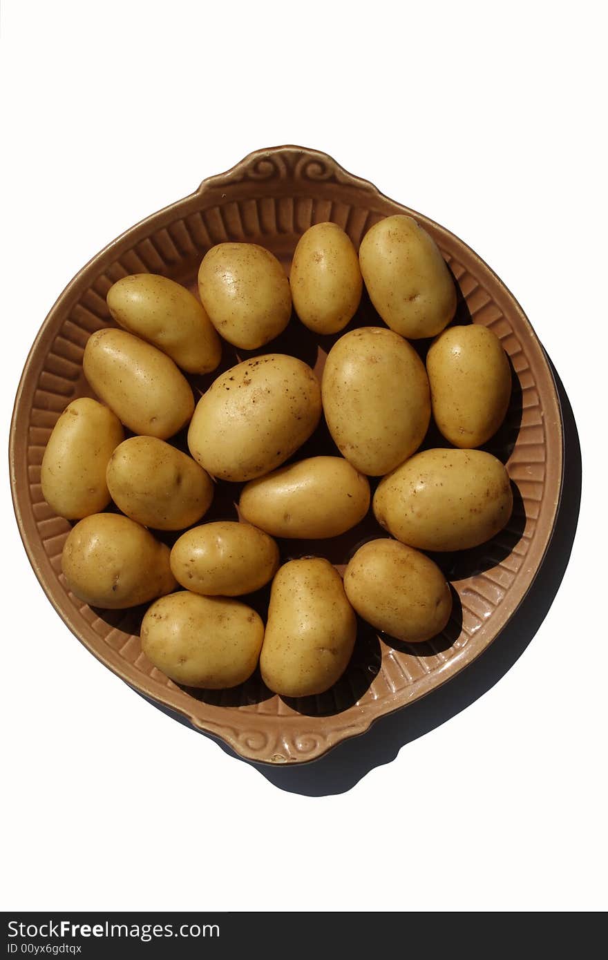 Potato on brown ceramick plate  isolated on white background. Potato on brown ceramick plate  isolated on white background