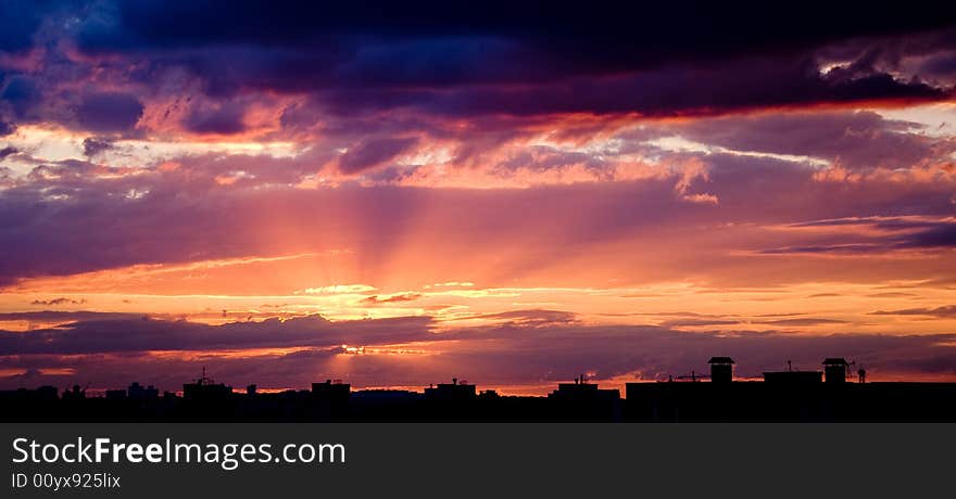 Silhouette of the roofs of houses at sunset.