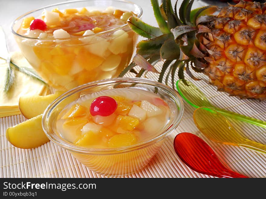 Fruit dessert in a bowl and a pineapple