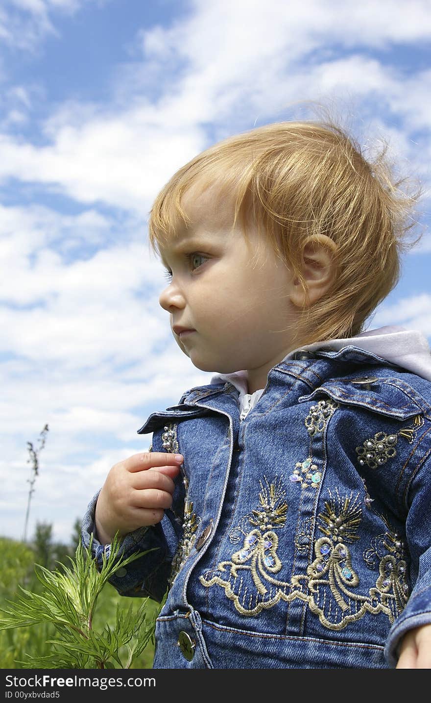 The clever little girl on a background of the sky. The clever little girl on a background of the sky