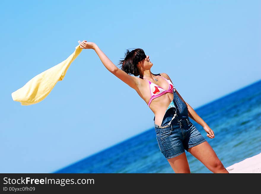 Young attractive woman enjoying summertime on the beach. Young attractive woman enjoying summertime on the beach