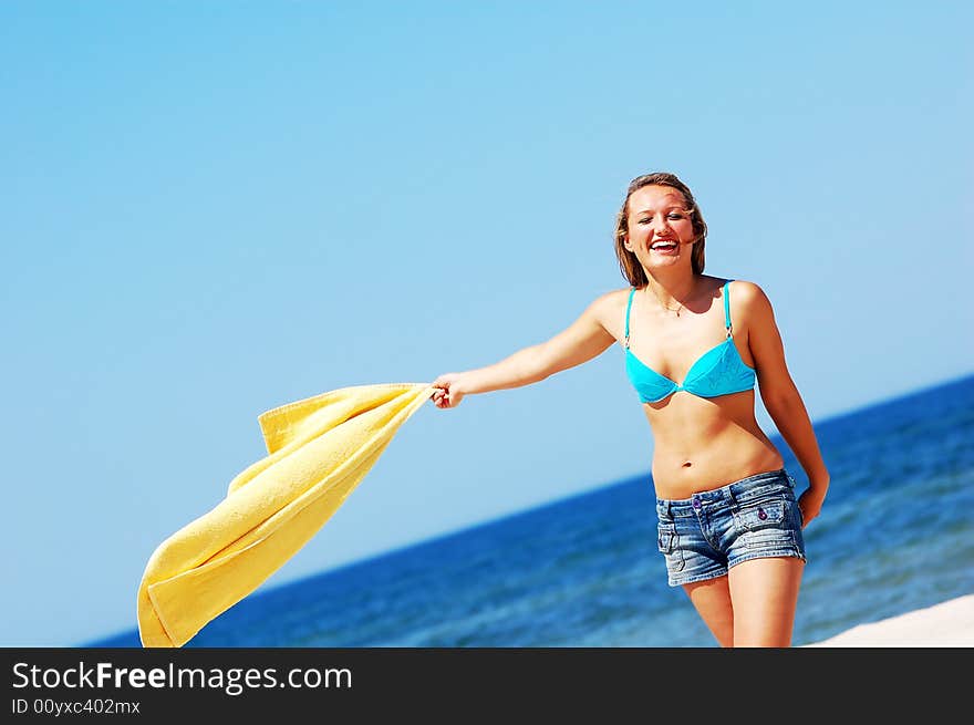 Young attractive woman enjoying summertime on the beach. Young attractive woman enjoying summertime on the beach