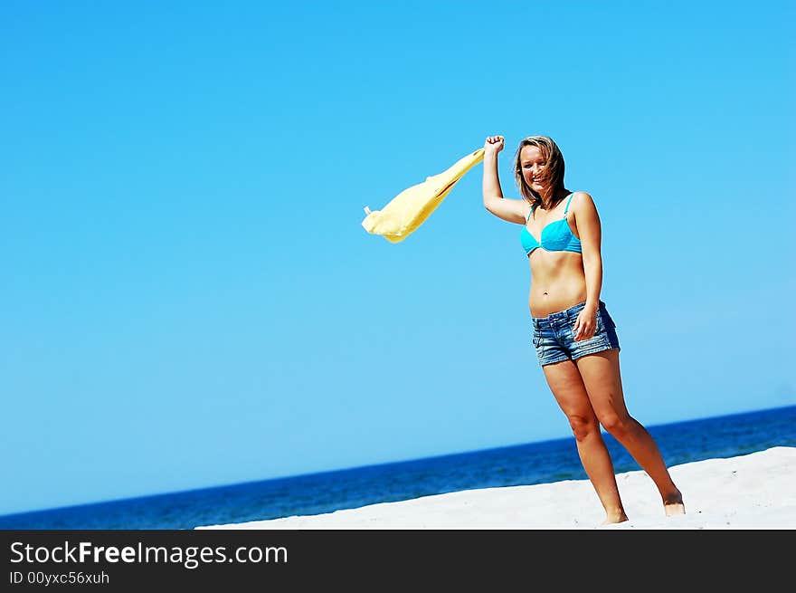 Young attractive woman enjoying summertime on the beach. Young attractive woman enjoying summertime on the beach